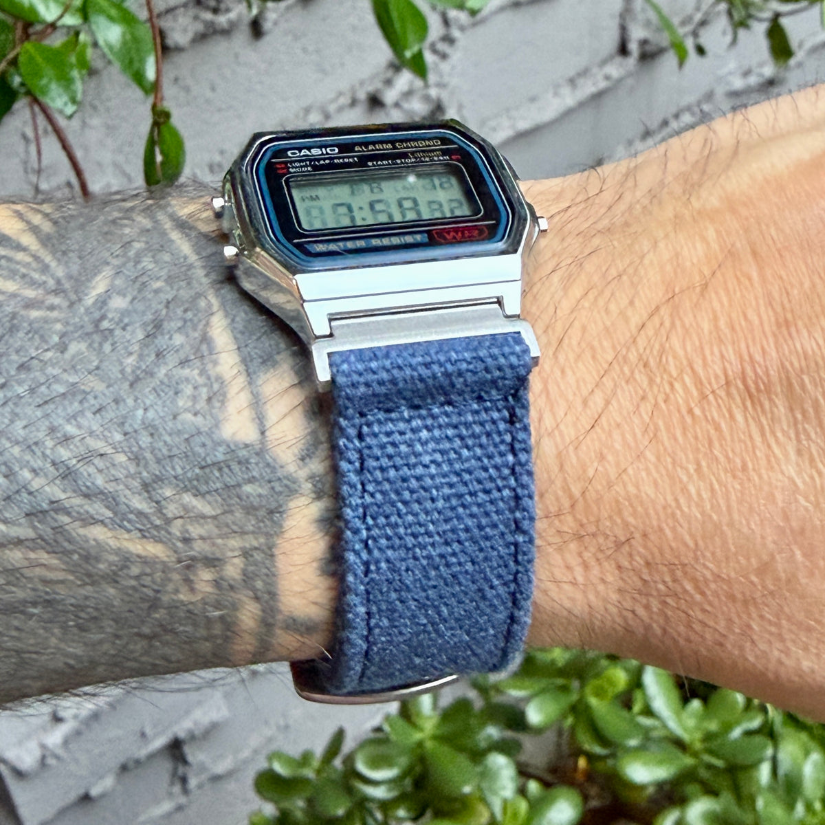Casio A158W with navy canvas strap and brushed silver adapters