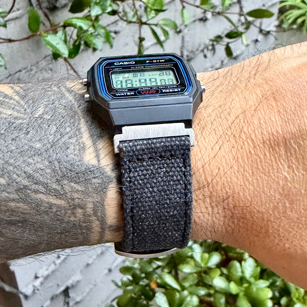 Casio F-91W with charcoal canvas strap and brushed silver adapters